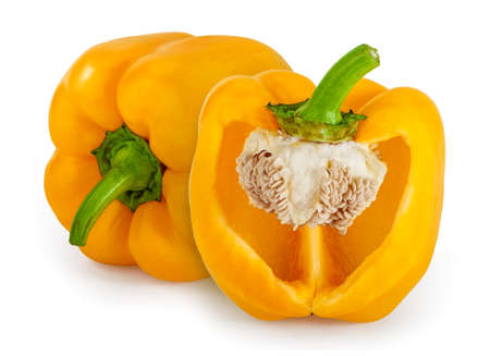 One whole yellow bell pepper and one cut in half, isolated on white.の写真素材