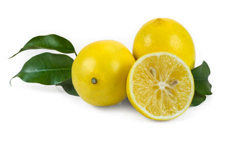 Two and a half fresh lemons with leaves on a white background.の写真素材