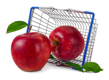 Red apples (Red Delicious) spilling out of overturned shopping mini basket on white background.の写真素材