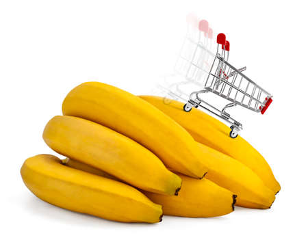 A miniature shopping trolley with fast moving effect over bunch of bananas. Concept of speed, rush and energy.の写真素材
