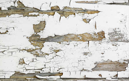 Old cracked peeling paint pattern on wooden background.の写真素材