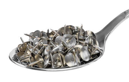 A spoon full of drawing pins (or thumb tack) as a symbol of health fraud. Quackery is the promotion...