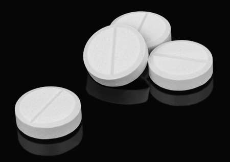 Tablets are the most commonly prescribed dosage form for getting drugs into the body. A scored line is provided in the middle of a tablet to make them easier to break in half if is required.の写真素材