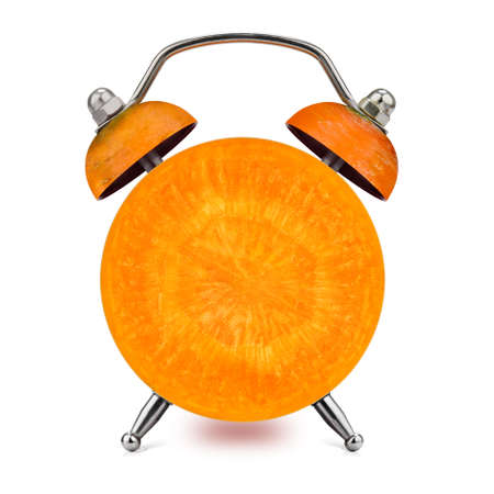 Cross-section of the carrot as an alarm clock on a white background. Healthy time concept.の写真素材