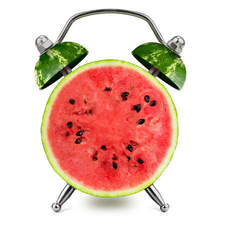 Halved watermelon as an alarm clock on a white background. Healthy time concept.の写真素材