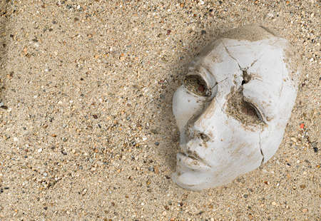 High-Resolution Archeology background. Broken plaster sculpture of a woman's face, covered with sand.の写真素材