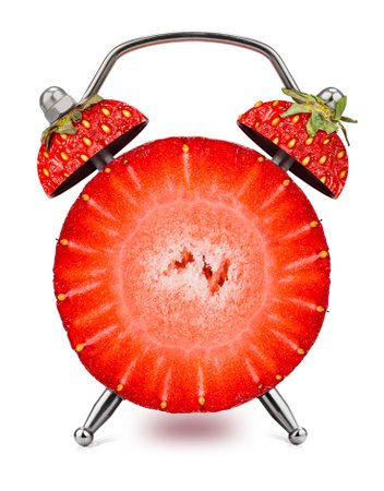 Cut Strawberry as an alarm clock on a white background. Healthy time concept.の写真素材