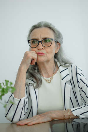 Closeup portrait of angry upset senior mature businesswoman at the office. Negative emotion, facial expressionの写真素材