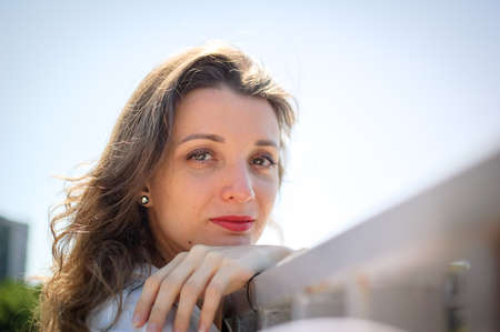 Close up female portrait of young active girl in white shirt outdoors during summer, happy people conceptの写真素材