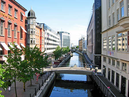 Aarhus, Denmark - June 6, 2009: People strolling on the promenade along the river Ã ... in downtown Aarhus in Denmark. The many restaurants, cafes and shops along the river attract Both locals and tourists.のeditorial素材