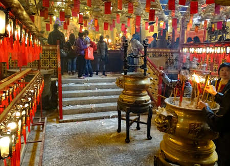 Sheung Wan, Hong Kong - February 10, 2016: During the Chinese New Year people kindle incense sticks in the Man Mo Temple in Sheung Wan, Hong Kong. Build in 1847 it is dedicated to the gods Man Cheong (God of Literature) and Mo and Tai (God of Martial artsのeditorial素材