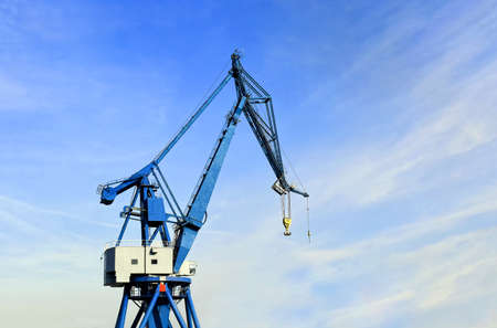 Port crane against a blue sky with a light cloud coverの写真素材