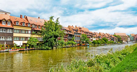 River Regnitz along historic half-timbered houses in the old town of Bamberg (Germany)の写真素材