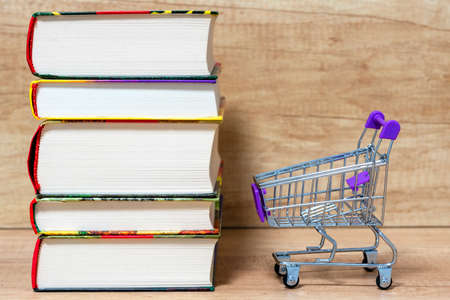 stack of books .Trolley. Concept of book trade, book business, knowledge priceの写真素材