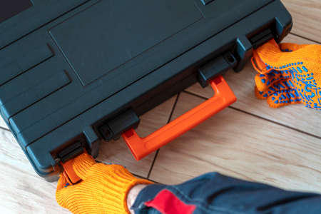 person with a case. master with tool box.close up. Worker gear concept