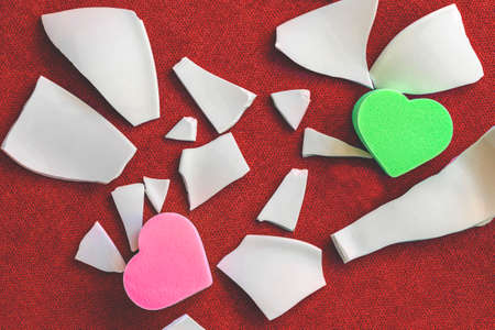 Hearts among the fragments. Symbol of unhappy love. White shards and two heartsの写真素材