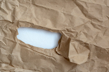 hole in paper with color paper background inside. Good paper texture.torn hole in paper.paper ripped...