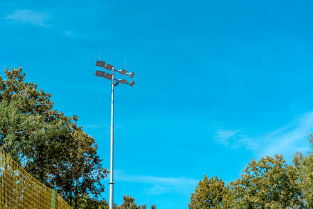 Searchlights. Lighting of the football field, soccer stadium. Lighting mast on a background of a blue sky. spotlightsの写真素材