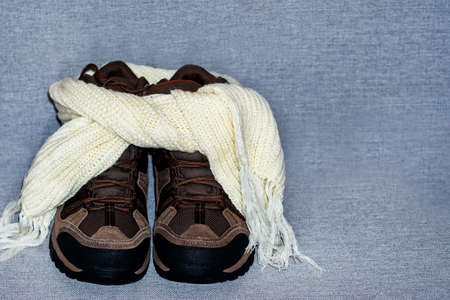 winter boots wrapped with a scarf. Warm shoes in winter. The concept of cold, winter, insulation