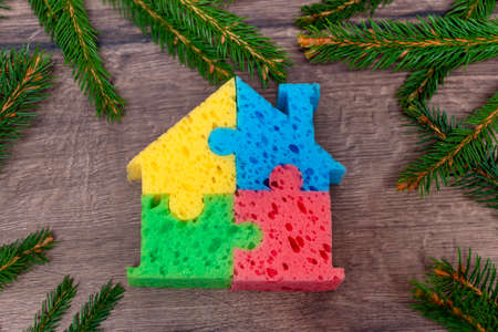 house on christmas background.Colored house on a background with spruce branchesの写真素材
