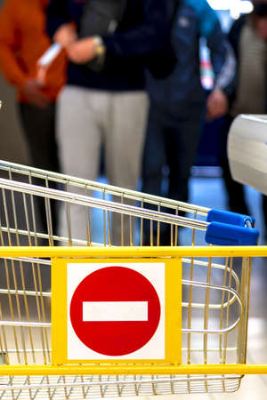 Trolley in the store. stop sign. Concept of ban, end of trade. Closed shops. Store barrierの写真素材