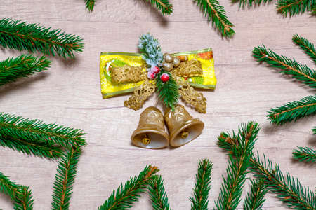 christmas decoration background. Bells on a background with spruce branches