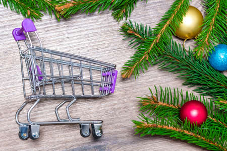 Trolley. Branches of a Christmas tree. Cart. Concept for Christmas shopping.の写真素材