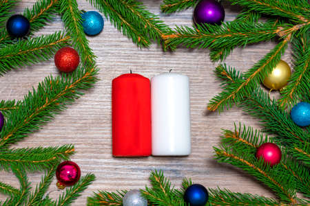 christmas decoration background. candles on a background with spruce branchesの写真素材