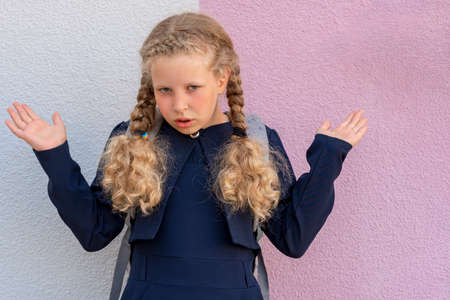 Portrait of a girl on the background. Girl's hand on the background. pupil, learner, scholar. copyspace. copyspace.の写真素材