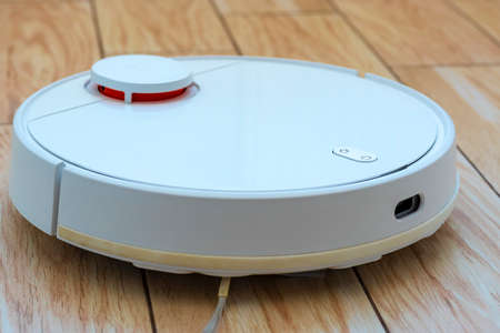 White robot vacuum cleaner.Garbage container. close up