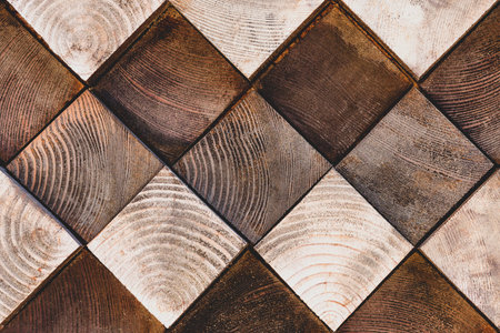 Texture square wooden bars of different colors and shades. Chess background of a tree. Wood cube wallpaper, shell texture, dark and light brownの写真素材