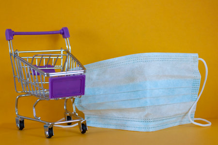 protective mask , store trolley. Concept Shortage of medical supplies. Concept Quarantine Markets, Shops, Supermarketsの写真素材