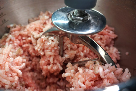 close up. the crushed meat on the meat grinder. Mincemeat in a bowl.