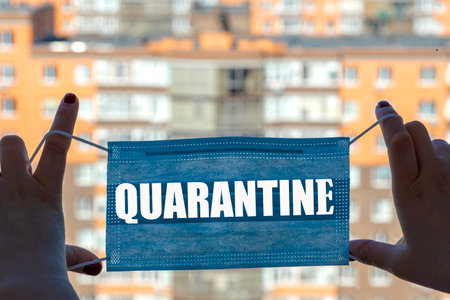 Protective mask in hands backdrop of the city. description mask quarantine, Face mask protection against pollution, virus, flu and coronavirus. Health care, self isolation concept.の写真素材