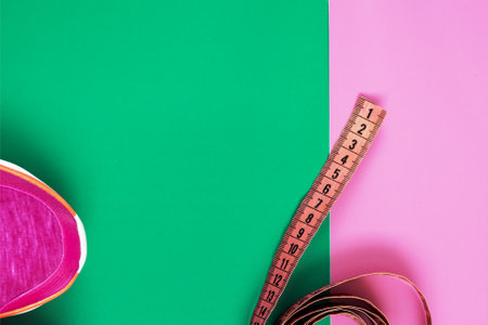 sneakers on a colored surface. sport shoes on colorful background. Fitness accessories. Measuring tape, centimeter. Concept Partners involved in sports. The concept of joint sports. Top view. copy space.の写真素材