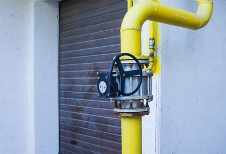 yellow valve on the gas pipe. Providing with natural gas population. transfer and adjustment of...