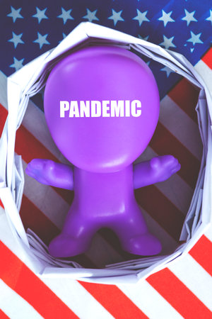 person figure with the description pandemic. man on the background of the USA flag. USA Coronavirus Pandemic Concept. The concept of quarantine, flu, coronavirus.の写真素材