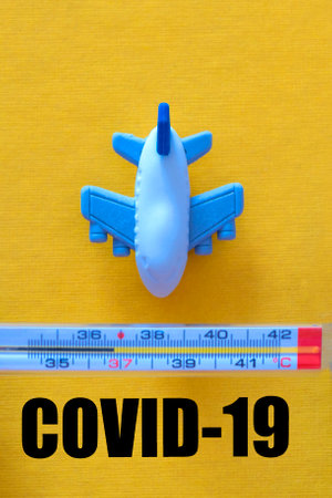 Airplane, Thermometer. Air travel prohibited. Closed airports from coronavirus. Temperature measurement for passengers on airliners. The concept of quarantine, flu, coronavirus.の写真素材