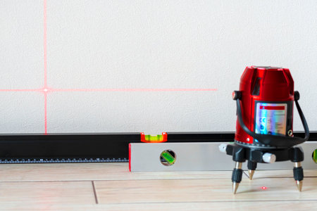 Laser level and Bubble levels, lines on the wall. measuring with red laser level.Measurement accuracy concept, modern measurement devicesの写真素材