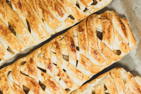 Fruit homemade pies. delicious dried fruit cakes background. Baked braided pigtails with fruits. pigtail of dough. dried fruit cake Concept cake deliciousの写真素材