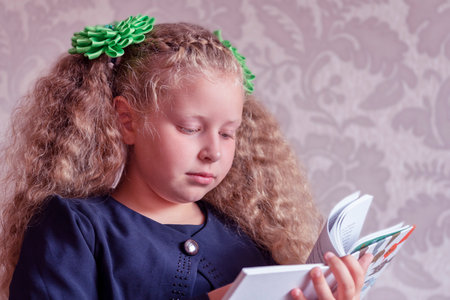 Portrait of a schoolgirl. Concept school days, Back to school. girl in a uniform. pupil, learner, scholar. A student with bookの写真素材