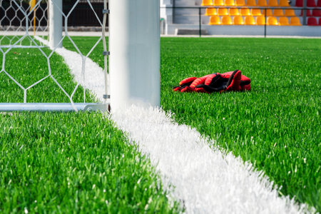Grid of a football goal. A look with a side. Concept other party of soccer. Goalkeeper gloves at the football goal.の写真素材