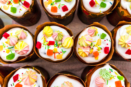 Easter cake, pie. Kulich, pie wrapped in paper. Easter cupcake with white glazeの写真素材