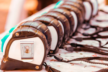 tape-measures. Ranks of tape-measures. Concept three options, opinions, assumptions, expert, professional. Measurement of the size of a frame of a window tape measure. Close-upの写真素材