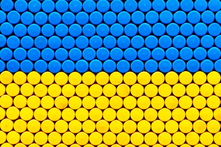 Xing yellow Texture, background from cork of plastic bottles.Blue and yellow colors of national flag of Sweden, Ukraineの写真素材