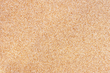 background of disseminated sand small gravel, a stone crumb. Texture of a surface of a wall, light...