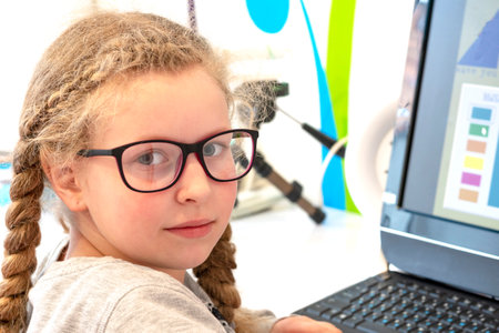 girl with glasses. A girl at the computer. The concept of vision treatment in children. Programs on...