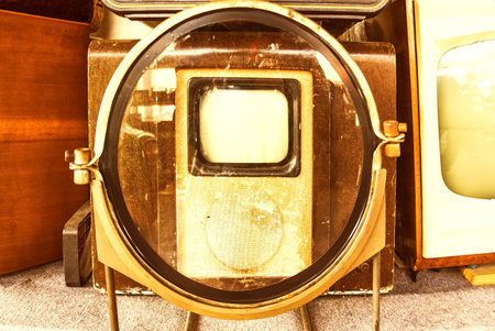 The old TV with magnifying glass. The first TV in the world. It is tinted. Vintage television receiverの写真素材