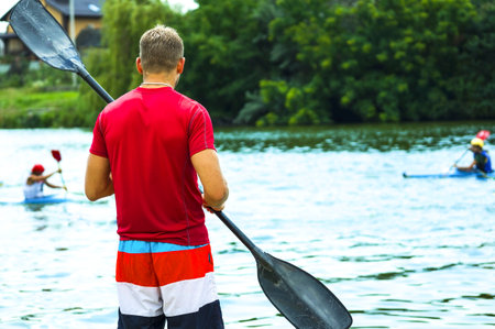 The man with an oar on the river. The guy who is engaged in SUP-Surfing.の写真素材