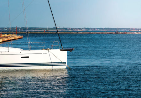Yacht moored at sea pier on sunny day on blue sky. Summer rest. cruise. Summer holidays. yacht, launch, boat, ocean, seaの写真素材